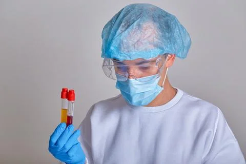 Laboratory technician examining blood sample tubes Stock Photos
