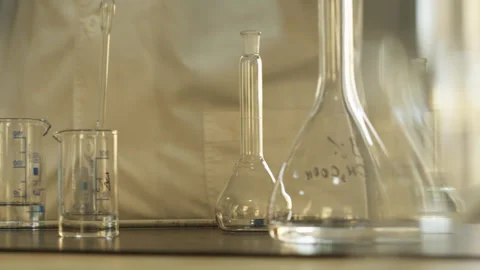 Laboratory technician in gloves and protective clothing working with pipette and Stock Footage 311502235