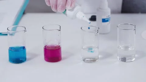 Laboratory technician hand is holding a plastic container and adding some Stock Footage 201344766