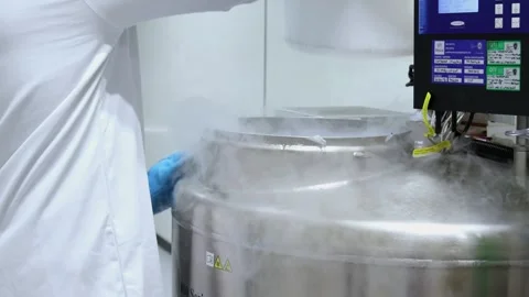 Laboratory technician handling cryogenic storage tank in scientific researc.. Stock Footage 296886401
