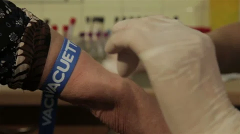 Laboratory technician inserting needle in patient vein and taking blood samples. Stock Footage 52259623