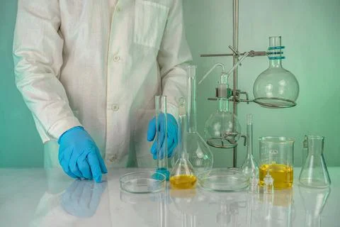 A laboratory technician involved in analyzing test tube measurements workin.. Stock Photos