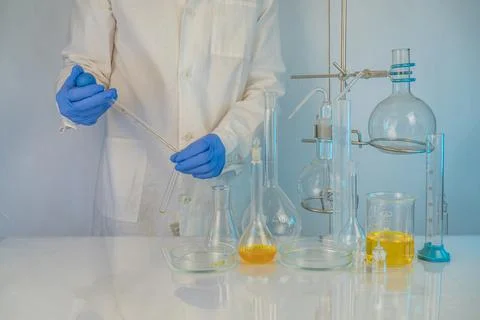 A laboratory technician involved in analyzing test tube measurements working  Stock Photos