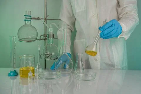 A laboratory technician involved in analyzing test tube measurements workin.. Stock Photos