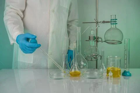 A laboratory technician involved in analyzing test tube measurements workin.. Stock Photos