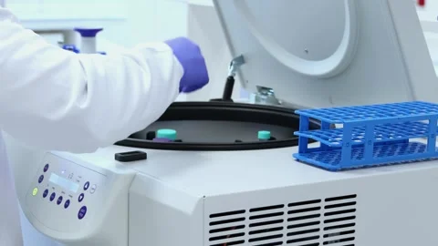 Laboratory technician loading samples into a centrifuge Stock Footage 296884880