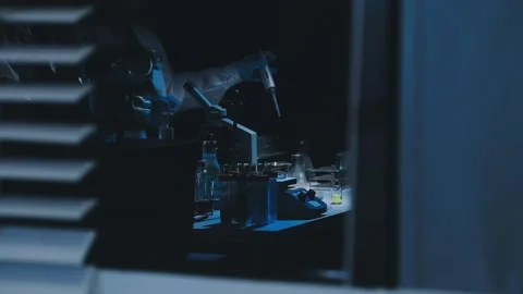 A laboratory technician makes microscopic bacteriological examination with .. Stock Footage 336485553