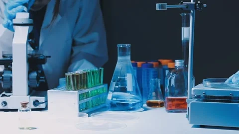 A laboratory technician makes microscopic bacteriological examination with .. Stock Footage 336485582