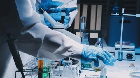 A laboratory technician makes microscopic bacteriological examination with .. Stock Footage 336485584
