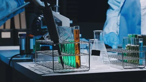 A laboratory technician makes microscopic bacteriological examination with .. Stock Footage 336485640