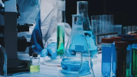 A laboratory technician makes microscopic bacteriological examination with .. Stock Footage 336485670