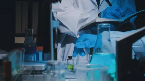 A laboratory technician makes microscopic bacteriological examination with .. Stock Footage 336485726