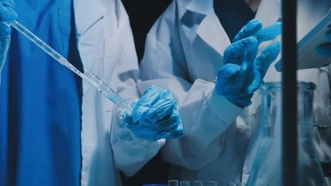 A laboratory technician makes microscopic bacteriological examination with .. Stock Footage 336485748