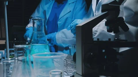 A laboratory technician makes microscopic bacteriological examination with .. Stock Footage 336485762