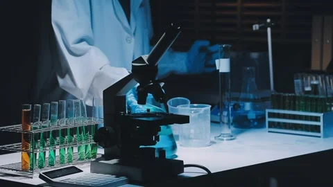 A laboratory technician makes microscopic bacteriological examination with .. Stock Footage 336485789