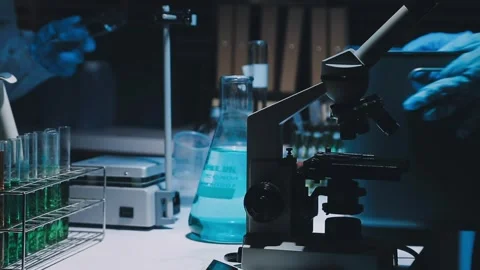 A laboratory technician makes microscopic bacteriological examination with .. Stock Footage 336485790