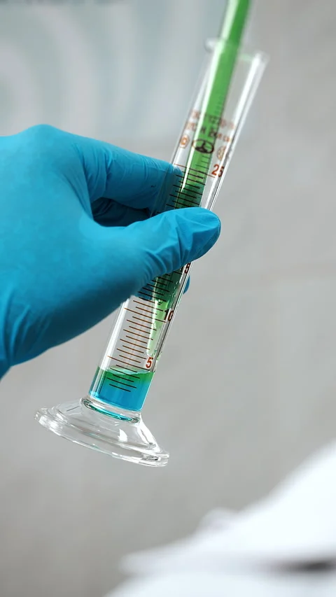 Laboratory Technician Measuring Liquid With Graduated Glass Pipette Stock Footage 345559912