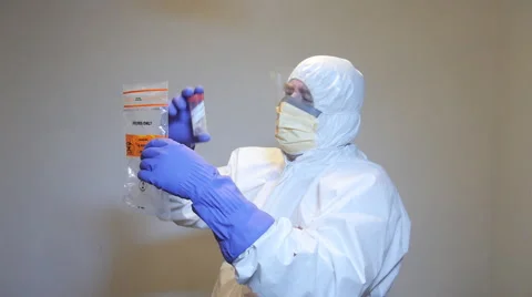 Laboratory technician placing specimen into bag. Stock Footage 60065558