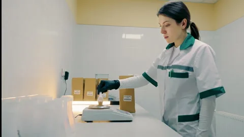 Laboratory Technician Pressing Button. Lab technician in white coat pressing a Stock Footage 260477894