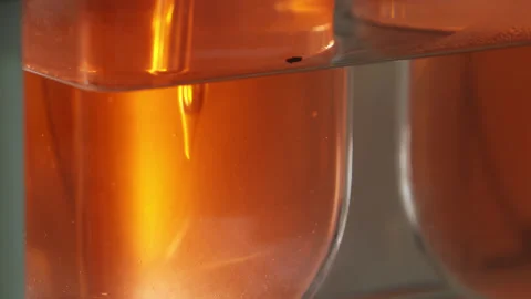 Laboratory technician in protective clothing taking chemical samples from Stock Footage 262440689