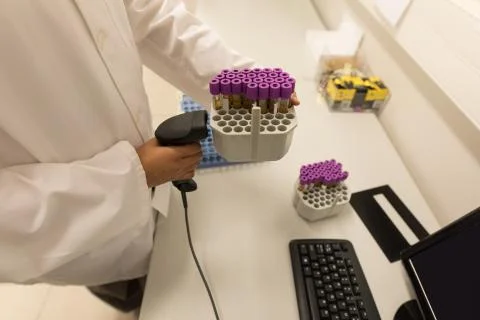 Laboratory technician scanning bar code of test tube rack Stock Photos