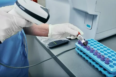Laboratory technician scanning barcode of test tube with blood. Barcode lab.. Stock Photos
