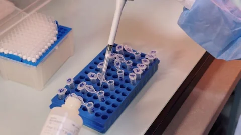 Laboratory technician taking samples of DNA profile fluid Stock Footage 311105725