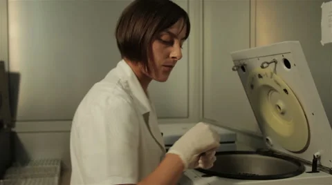 Laboratory technician taking test tubes with sample from device for analysis. Stock Footage 52259039