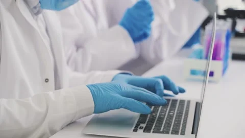 Laboratory technician typing on a laptop Stock Footage 231129904