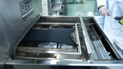 Laboratory Technician Using An Automated Machine For Analysis Of Fabric Stock Footage 334155214