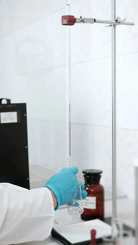 Laboratory Technician Using Burette for Chemical Analysis. Stock Footage 345546945