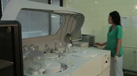 Laboratory technician working on the device for sample analysis, tracking shot. Stock-Footage 52330208