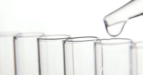 Laboratory test, pipette drips transparent chemicals into test tubes. Stock Footage 106200970