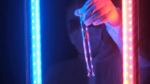 Laboratory test tube with a test sample of the plant in neon blue red light. Stock Footage 121301202