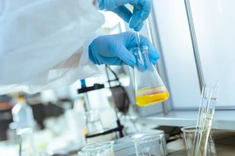 Laboratory Testing and Quality Control of Oil Sample by Scientist with Pipe.. Stock Photos