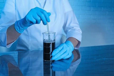 Laboratory testing. Scientist preparing soil extract at table indoors, clos.. Stock Photos