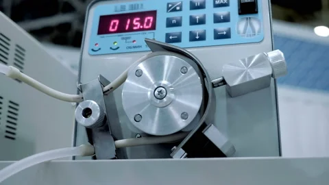 In the laboratory, a transparent solution is pumped through a silicone tube Stock-Footage 187441975