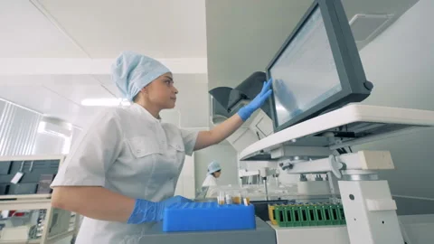 Laboratory unit with functioning equipment and several female experts working in Video stock 93736196
