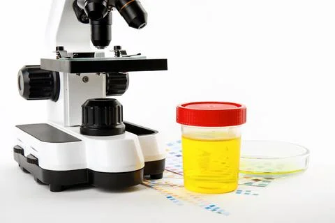 Laboratory ware with urine samples for analysis and microscope on white backg Stock Photos