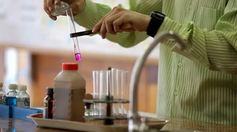 Laboratory work with chemicals .the mixing of the reactants in the flask Stock Footage 55440321