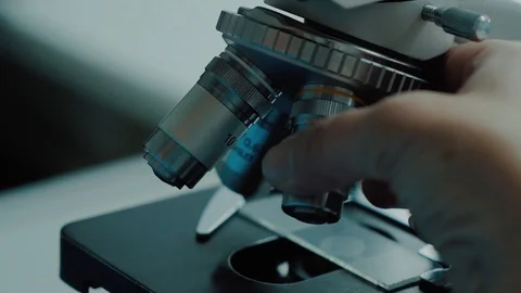 Laboratory worker is adjusting electron microscope performing analysis Stock Footage 99514843