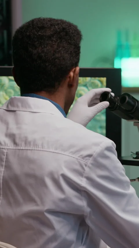 Laboratory Worker Analyzing Blood Sample and Using Microscope during Research Stock Footage 332359079
