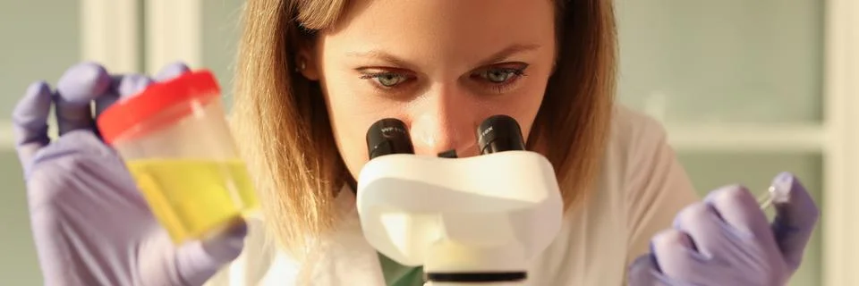 Laboratory worker does urine test using modern microscope Stock Photos