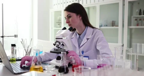 Laboratory worker examines delicate sample on glass slide Vídeos de archivo 318731176