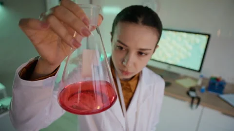 Laboratory Worker Holding Flask with Liquid Sample during Research Stock Footage 332365097