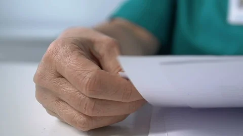 Laboratory worker looking through analysis results and putting glasses on table Stock Footage 119298895