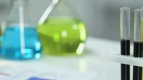 Laboratory worker marking test tube with refined oil sample fuel quality control Stock Footage 104572287