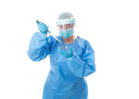 Laboratory worker or pathologist in full PPE with pipette and petri dish L... Stock Photos