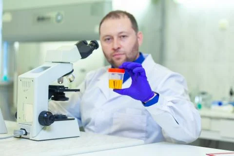 Laboratory worker performing urinalysis using microscope and laboratory Stock Photos
