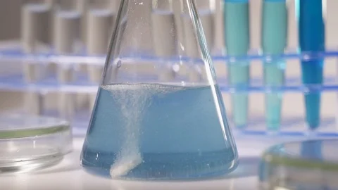 Laboratory worker scientist laboratory assistant tests chemicals for reactions Video stock 120560490